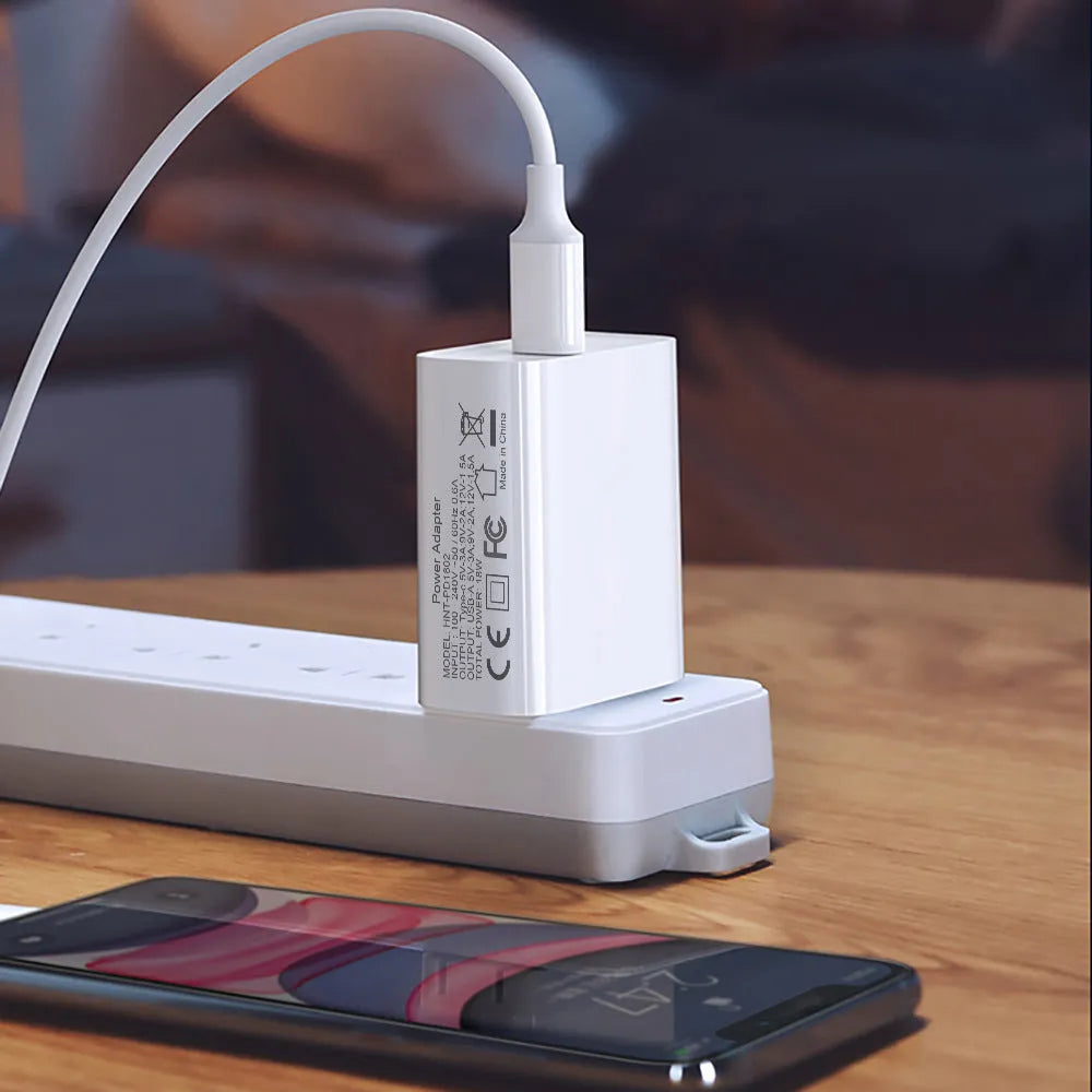 White 18W fast charger with USB Type-C and standard USB ports, shown with EU, UK, and US plug options.