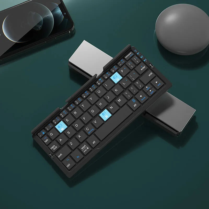 Aluminium folding Bluetooth keyboard open with phone on stand next to folded compact size