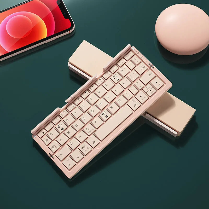Aluminium folding Bluetooth keyboard open with phone on stand next to folded compact size