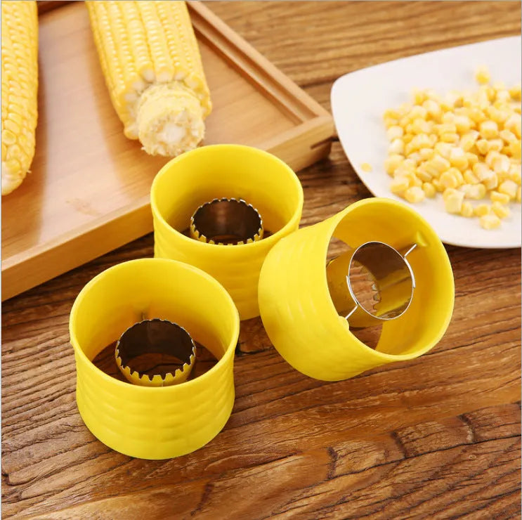 Yellow manual corn grinder thresher with corn-shaped PP grip and stainless steel gear.