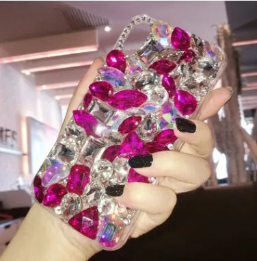 Clear rhinestone phone case for iPhone on a table showing crystal gem decoration