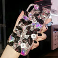 Clear rhinestone phone case for iPhone on a table showing crystal gem decoration
