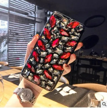 Clear rhinestone phone case for iPhone on a table showing crystal gem decoration