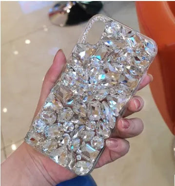 Clear rhinestone phone case for iPhone on a table showing crystal gem decoration