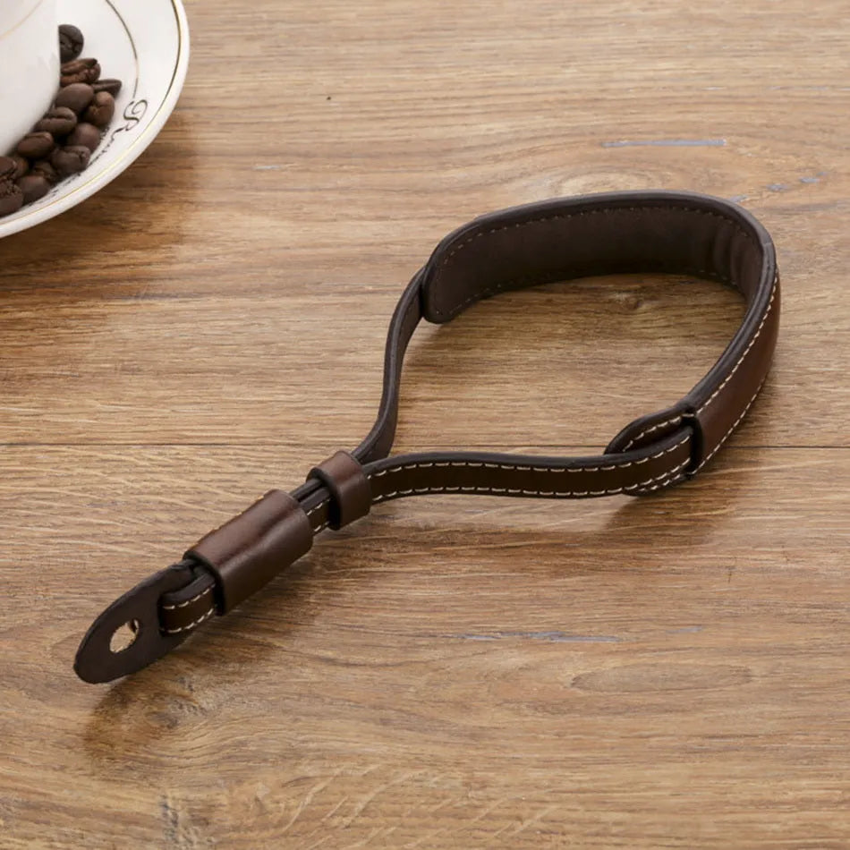 Black and brown universal camera wrist strap for DSLR and mirrorless cameras.