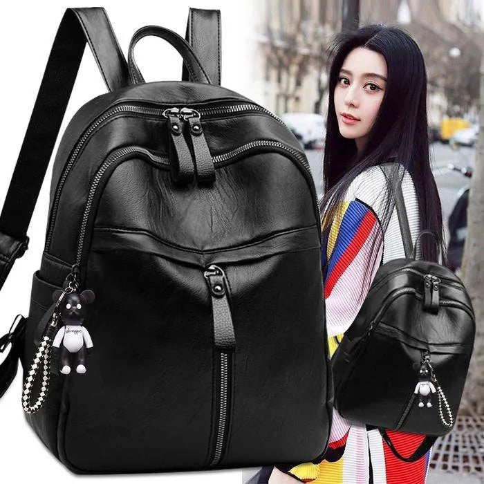Black soft surface PU leather medium backpack with double straps and a detachable pendant