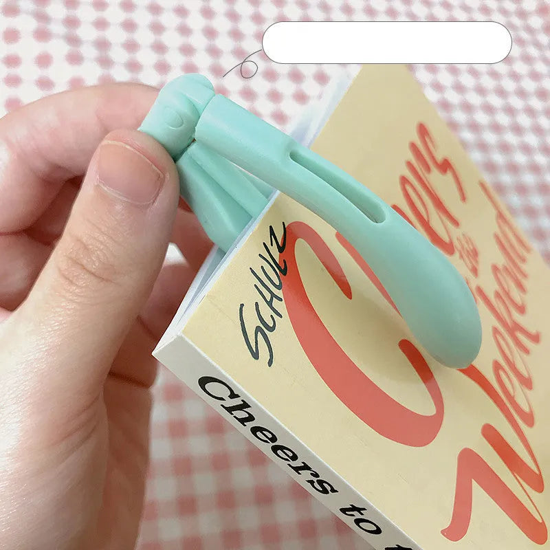 Folding battery-powered book light in blue colour, shown open and closed.