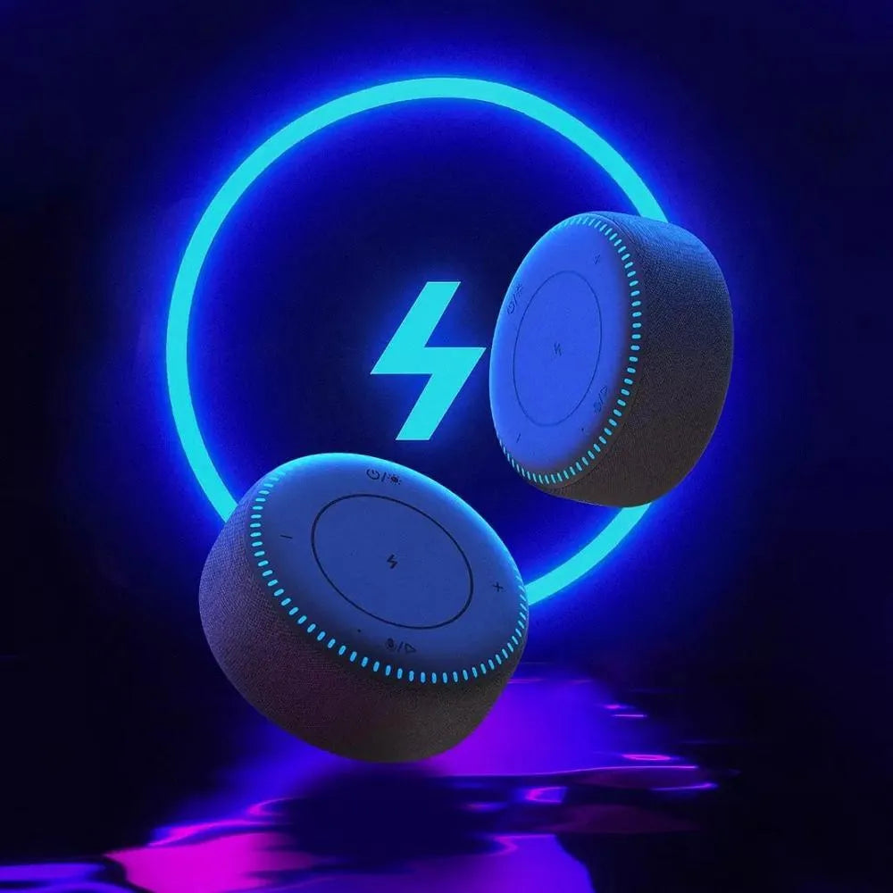 Black wireless charging Bluetooth speaker unit with USB port on a desktop.