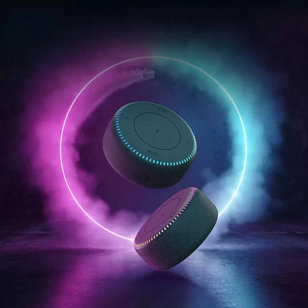 Black wireless charging Bluetooth speaker unit with USB port on a desktop.