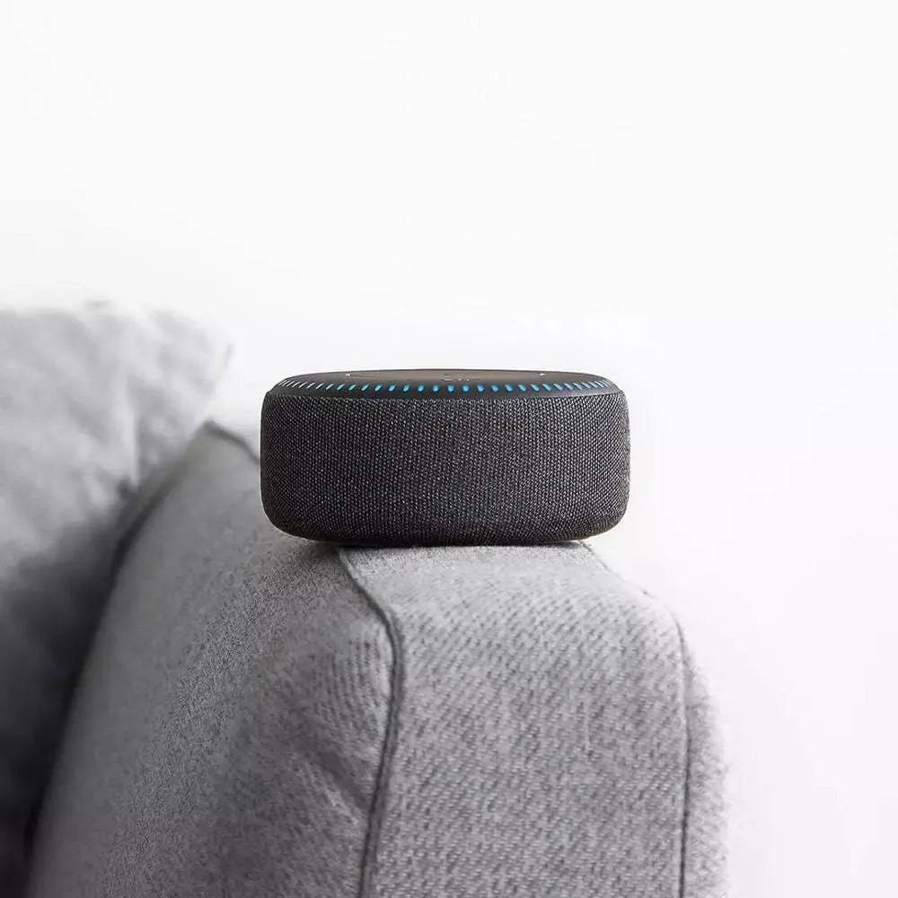 Black wireless charging Bluetooth speaker unit with USB port on a desktop.