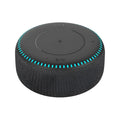 Black wireless charging Bluetooth speaker unit with USB port on a desktop.