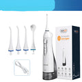 White portable oral irrigator water flosser with 330ml tank, 4 nozzles, and USB charging cable on a bathroom counter.
