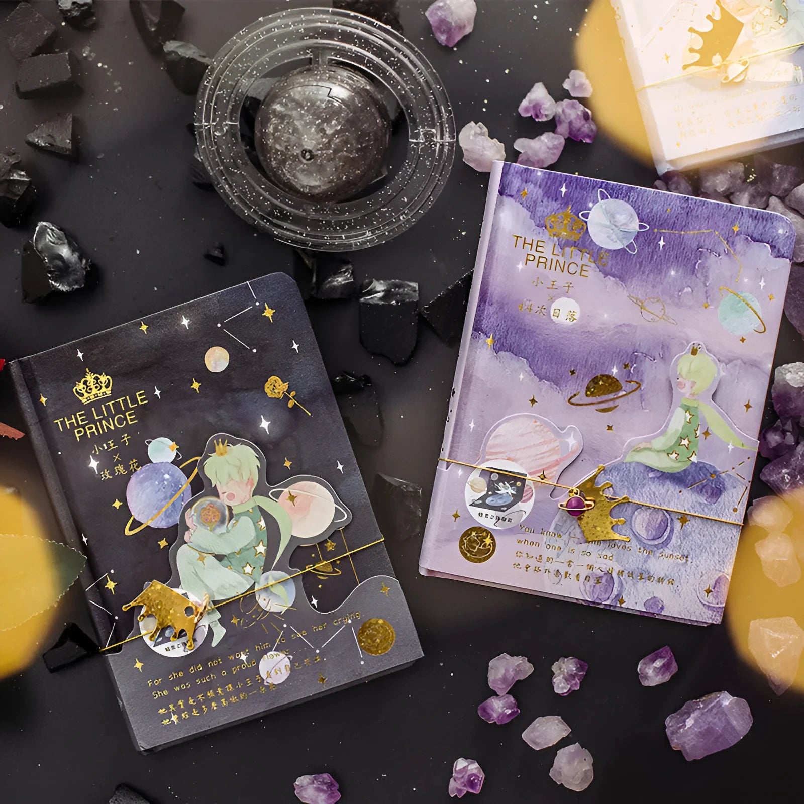 Hardback Little Prince notebook open on a table, showing one of four cover designs: sunset, bird, roses, or fox.