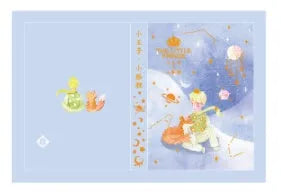 Hardback Little Prince notebook open on a table, showing one of four cover designs: sunset, bird, roses, or fox.