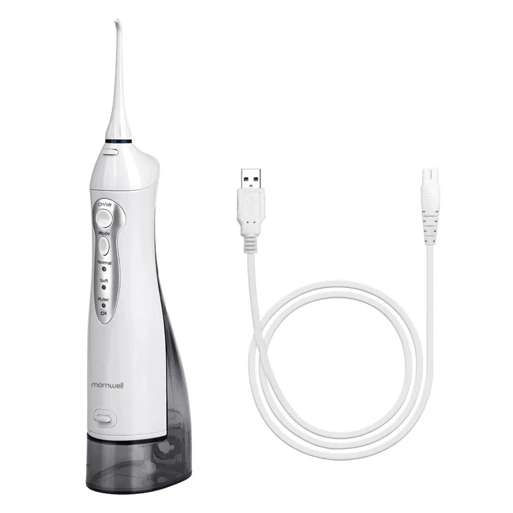 White portable oral irrigator water flosser with 330ml tank, 4 nozzles, and USB charging cable on a bathroom counter.