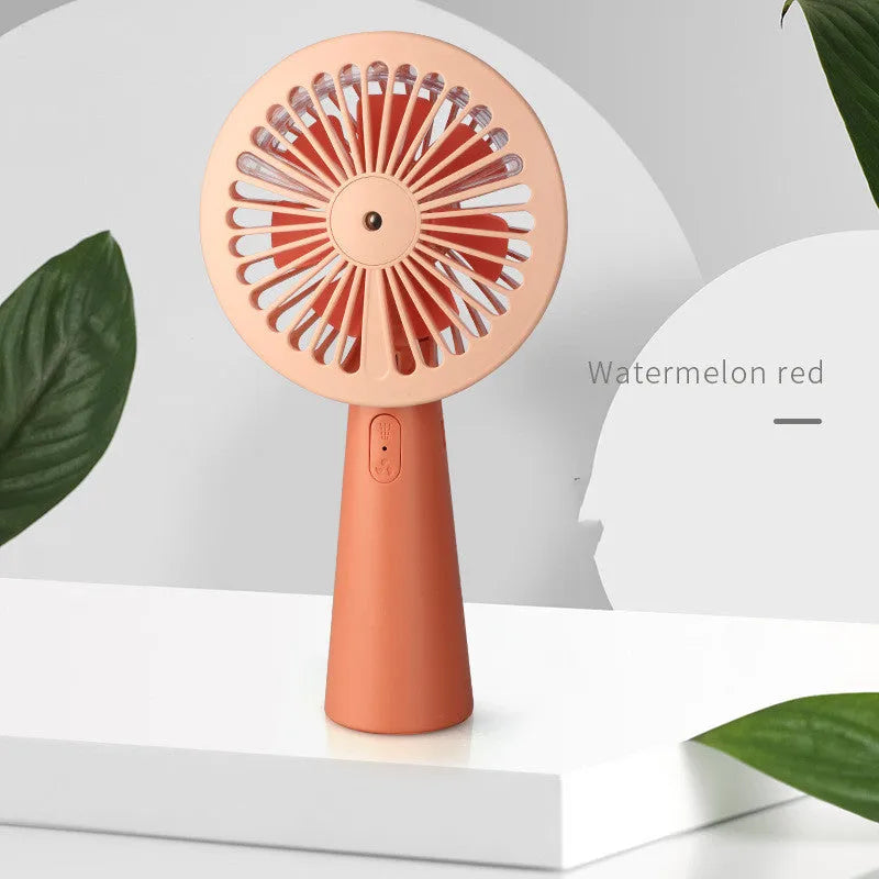 Nano spray fan handheld USB mini portable mist fan in green with plastic body and spray nozzle
