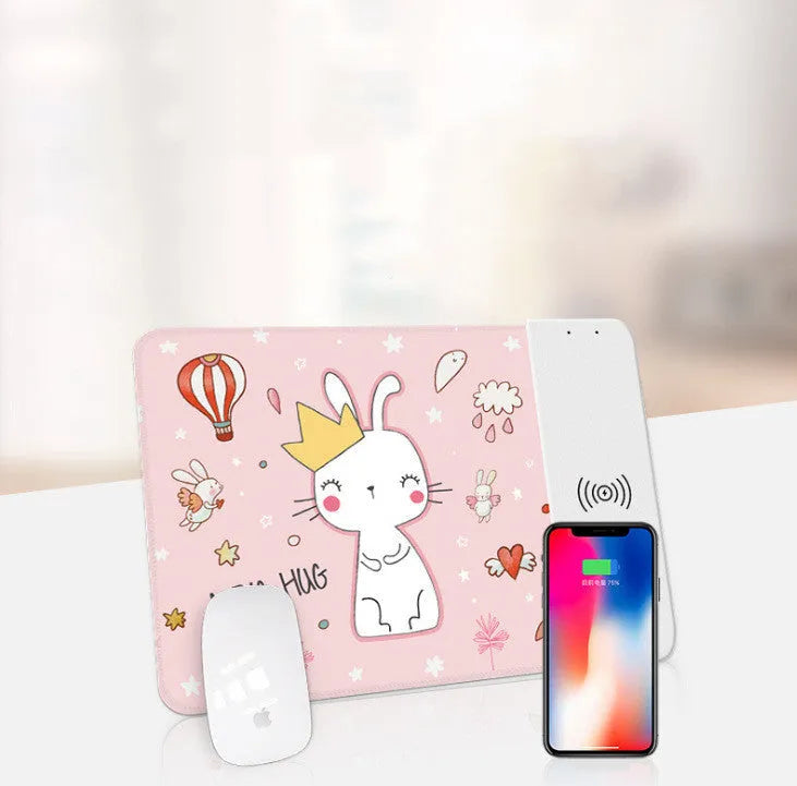 Black wireless charging mouse pad with RGB lighting and a cartoon design on a desk