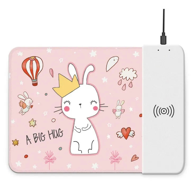 Black wireless charging mouse pad with RGB lighting and a cartoon design on a desk
