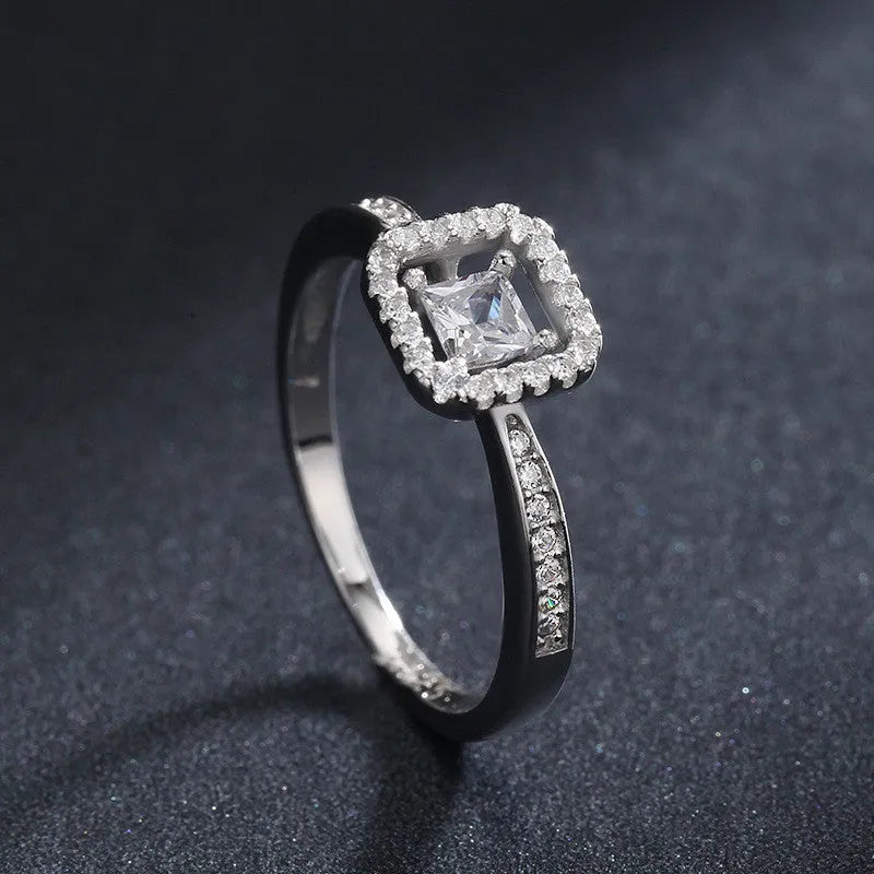 Square hollow 925 sterling silver ring with synthetic zirconia inlay on silver background