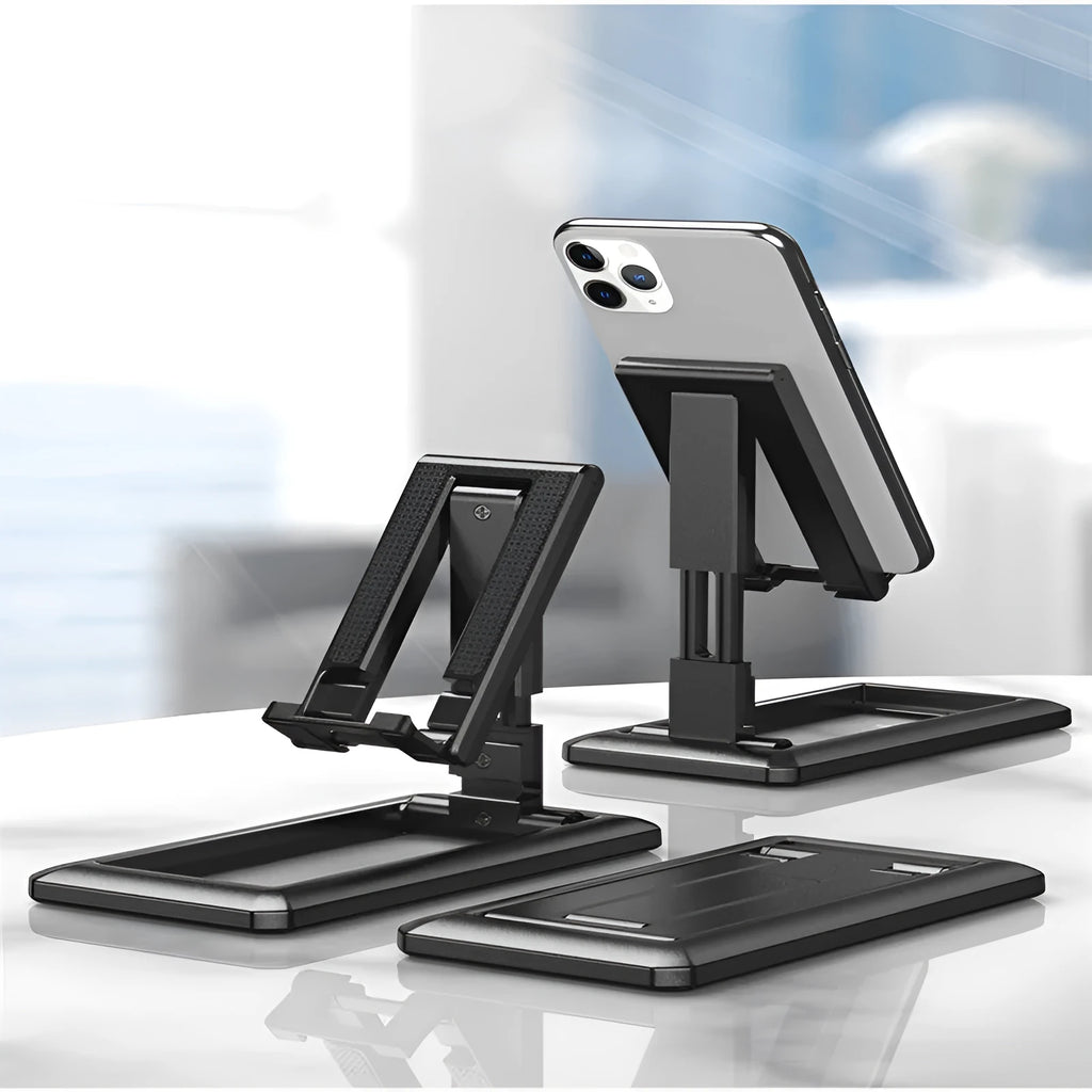 Retractable folding mobile phone stand in extended position on desktop