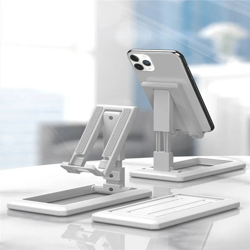 Retractable folding mobile phone stand in extended position on desktop