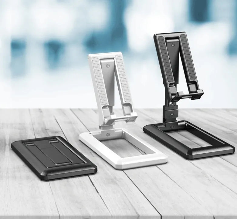 Retractable folding mobile phone stand in extended position on desktop