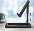 Retractable folding mobile phone stand in extended position on desktop