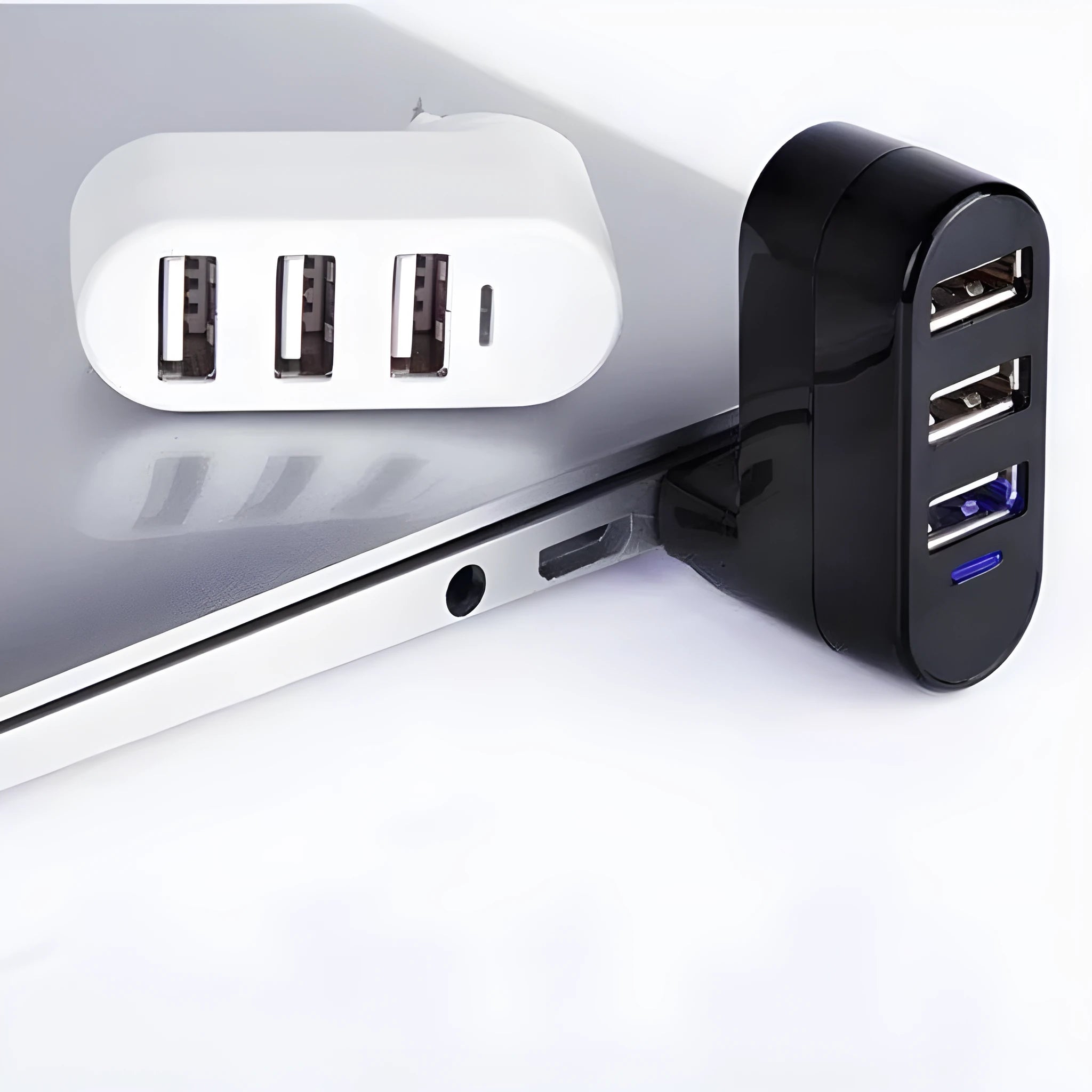 Black and white USB hub with a spinning multi-interface design on a desk.