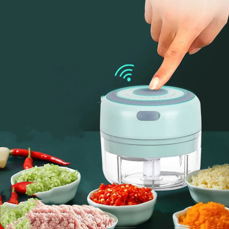 Mini electric garlic chopper with stainless steel blade and USB charging cable in green colour