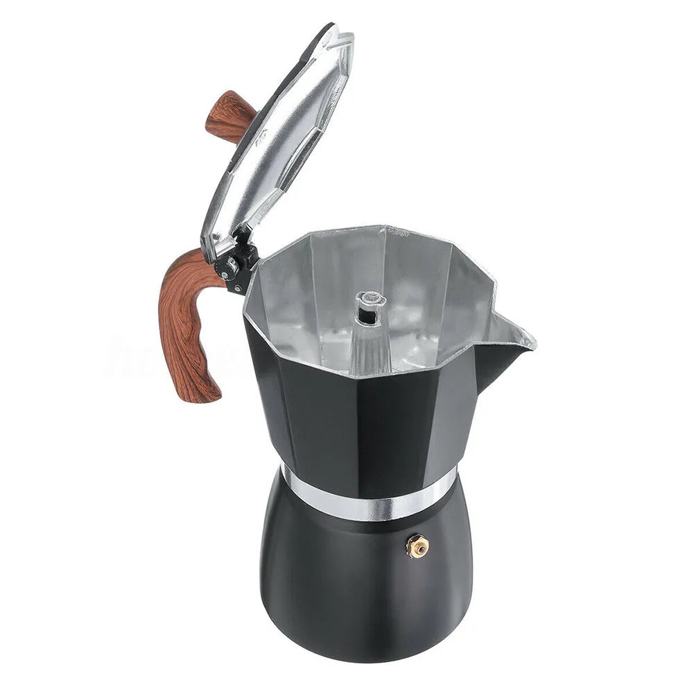 Italian mocha coffee pot in aluminium with long handle, black colour, standing on a stovetop