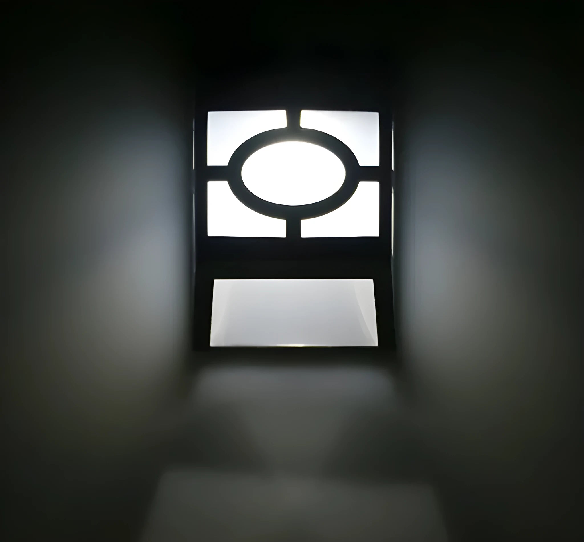 Retro-style white solar wall light with solar panel and two LEDs, shown next to a mounting screw.