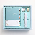 Peekaboo gift box A6 hand ledger notebook with pen in random blue, green, pink, or purple cover.