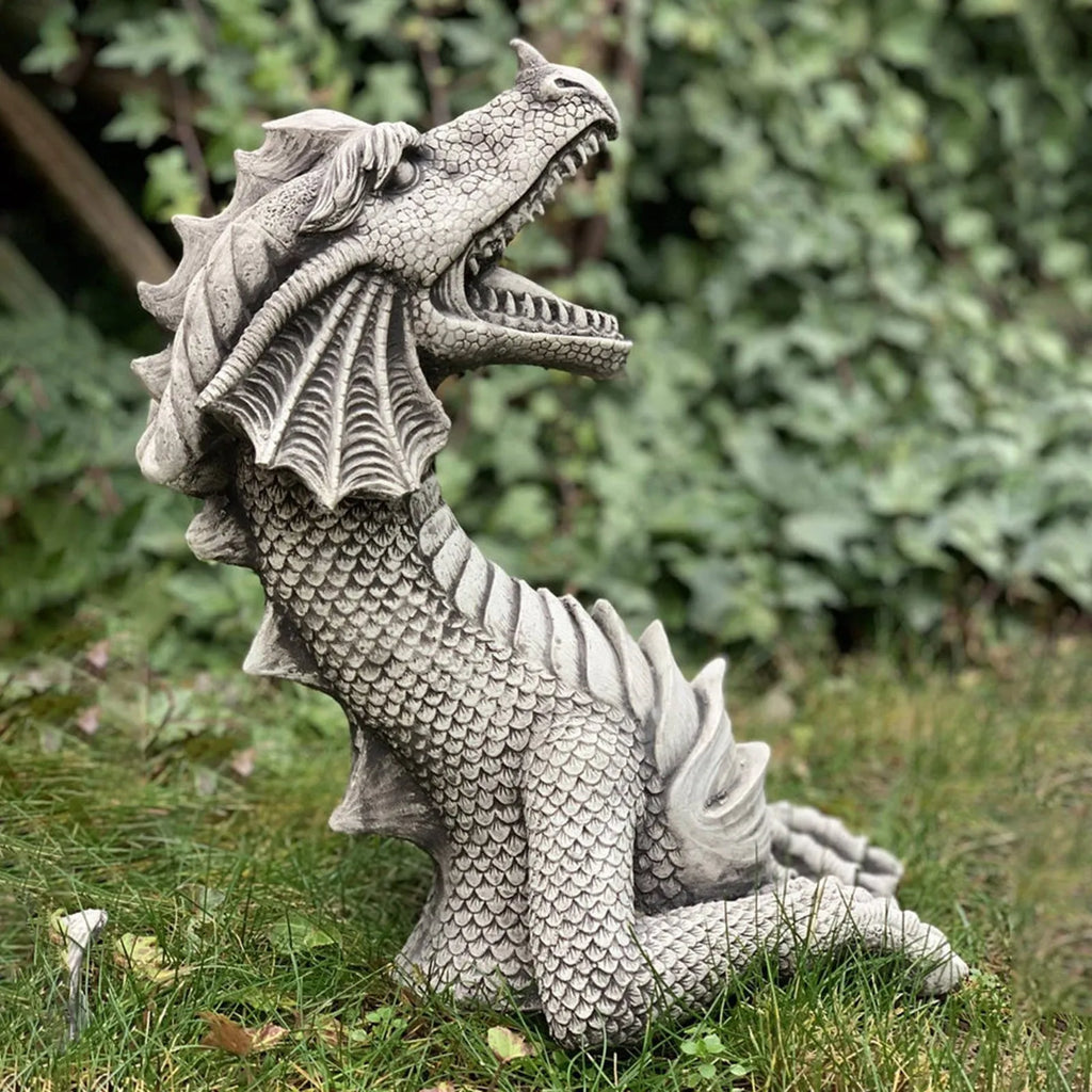 Large gothic dragon garden statue in charcoal gray stone with scales, wings, and tail, outdoor lawn decor