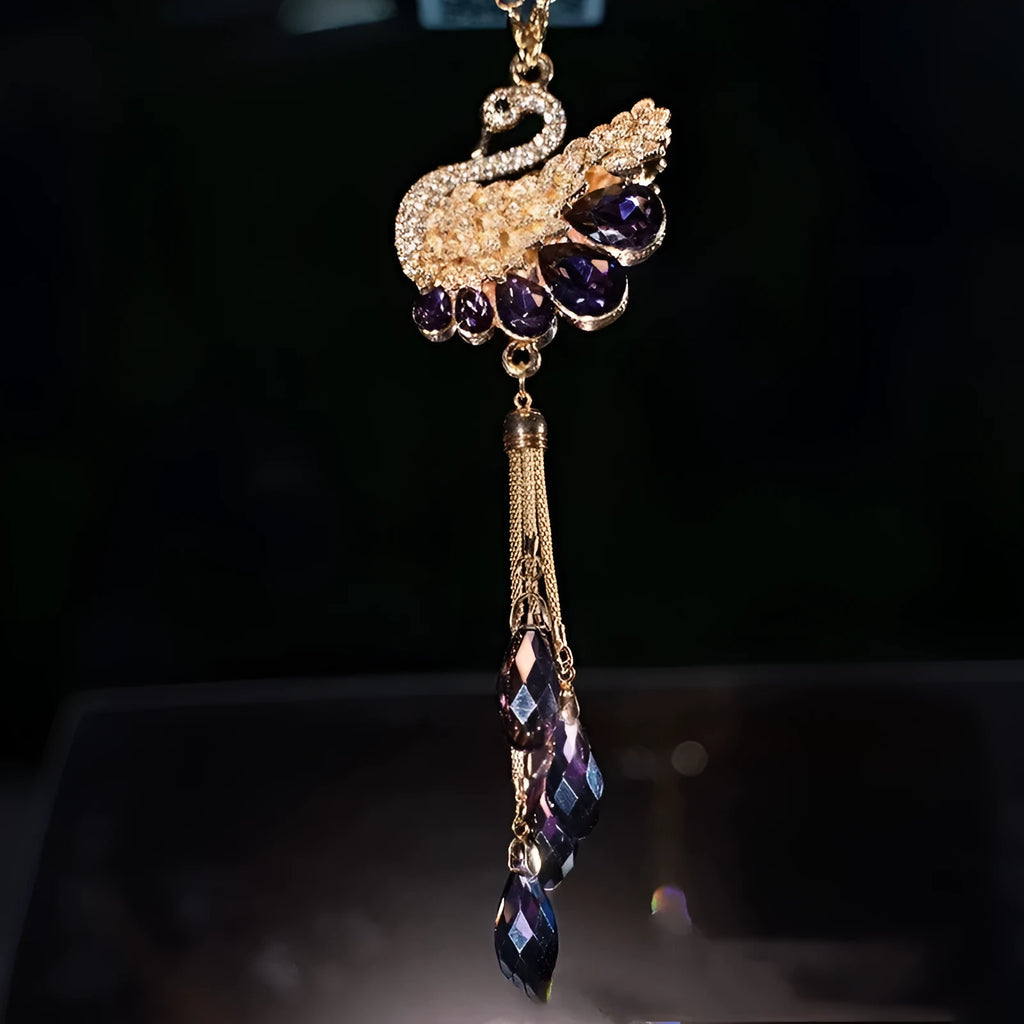 Double-sided crystal swan car pendant in blue metal and rhinestone, hanging from rearview mirror