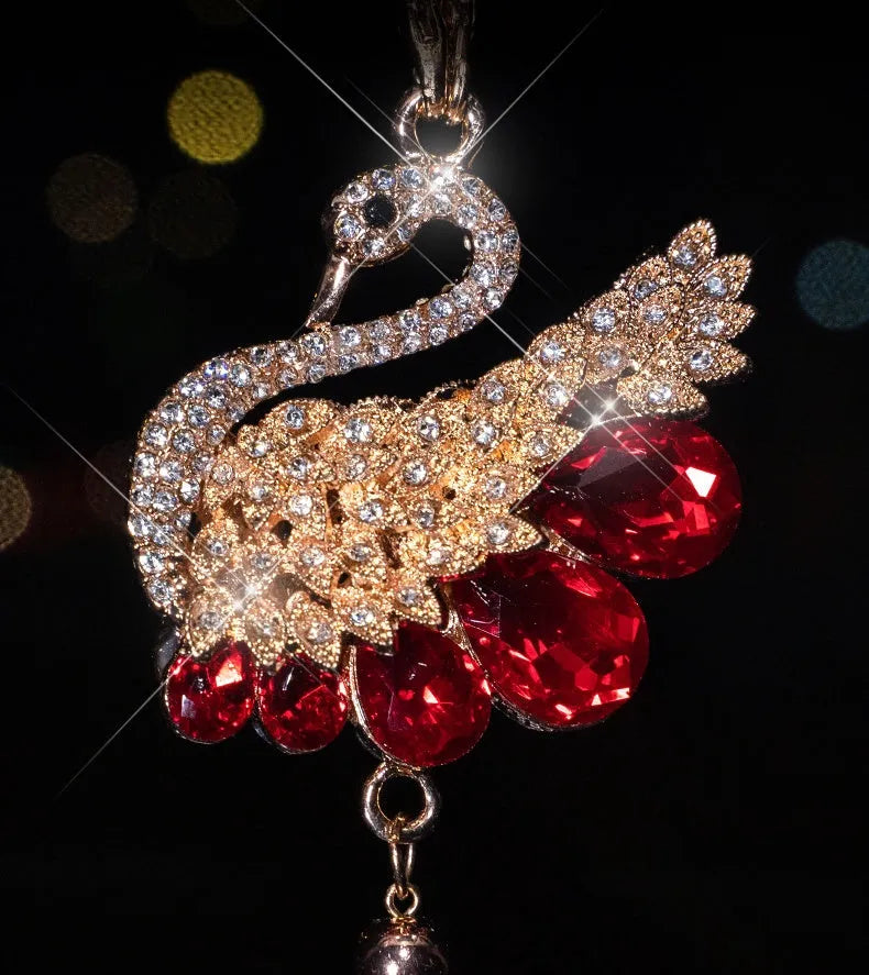 Double-sided crystal swan car pendant in blue metal and rhinestone, hanging from rearview mirror