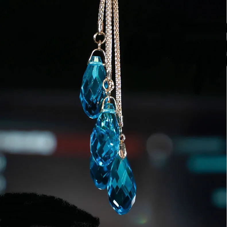 Double-sided crystal swan car pendant in blue metal and rhinestone, hanging from rearview mirror