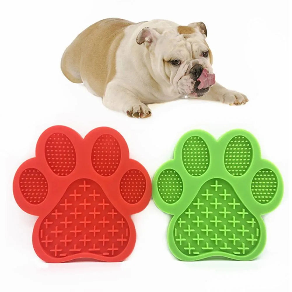 Paw-shaped silicone dog lick pad, 18cm x 18cm, food-grade BPA-free, shown in red with soft food spread on top