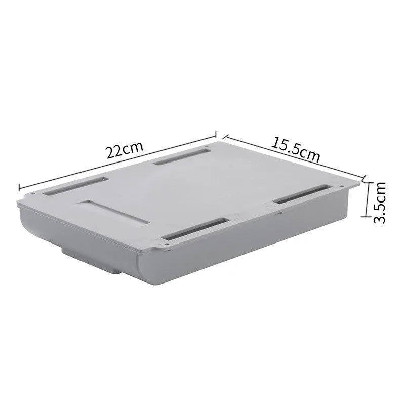 Grey Japanese style plastic drawer storage box placed under a table with stationery inside