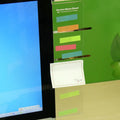 Transparent acrylic computer monitor side pane 28 by 7.8cm attached to screen showing notes