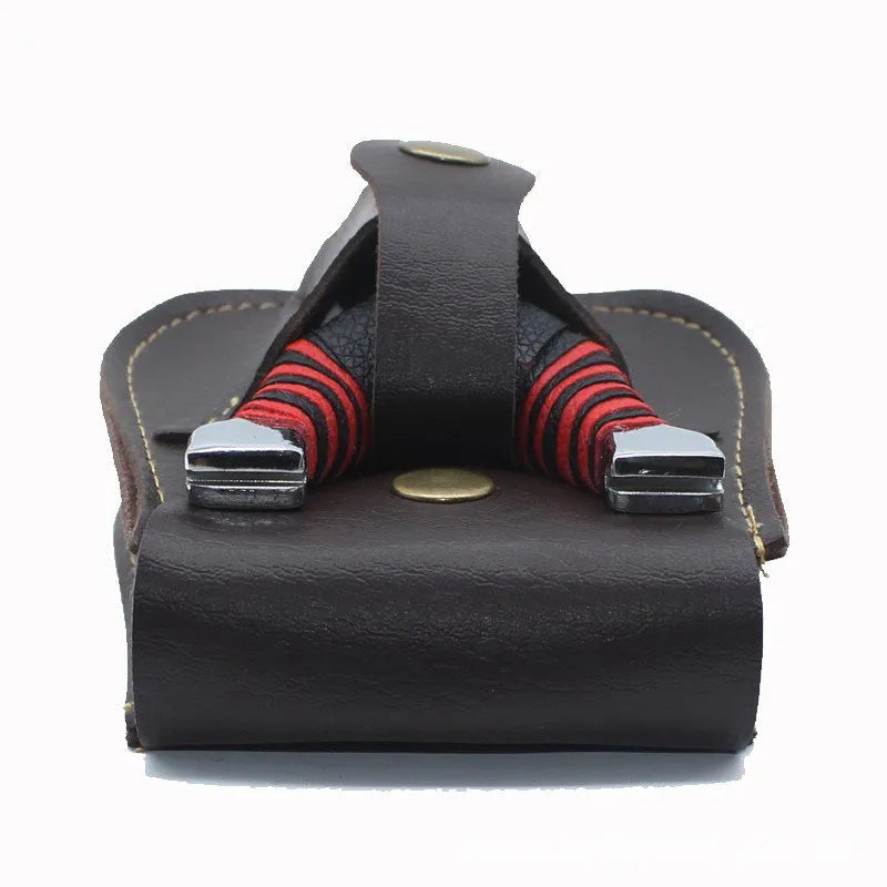 Leather slingshot belt bag in black, holding steel balls, attached to a belt for outdoor carry.