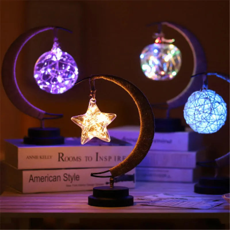 LED modelling lights with star, moon, apple, and round ball shaped covers on a warm white Christmas decoration display