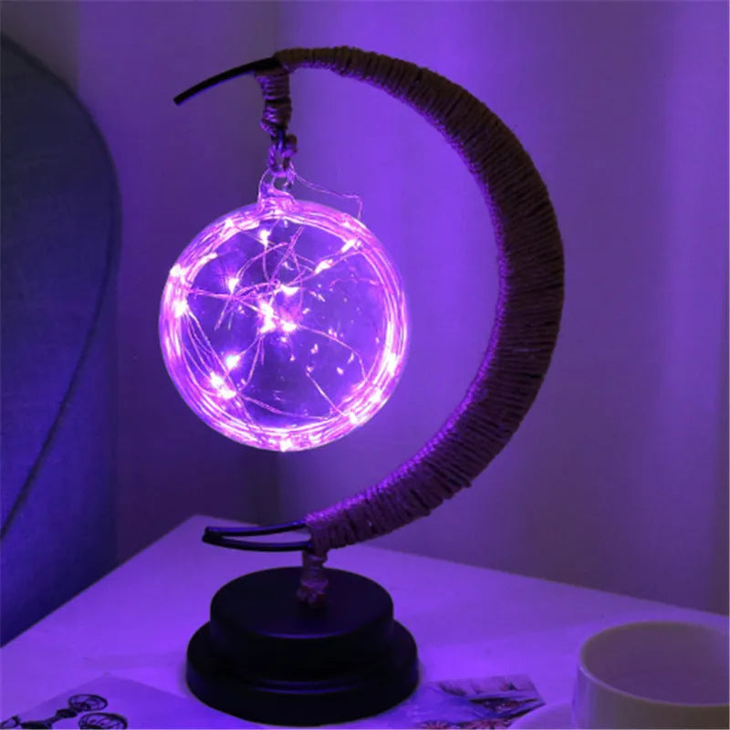 LED modelling lights with star, moon, apple, and round ball shaped covers on a warm white Christmas decoration display