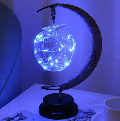 LED modelling lights with star, moon, apple, and round ball shaped covers on a warm white Christmas decoration display