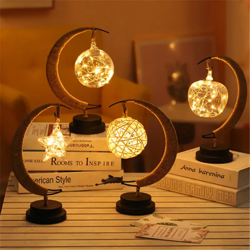 LED modelling lights with star, moon, apple, and round ball shaped covers on a warm white Christmas decoration display