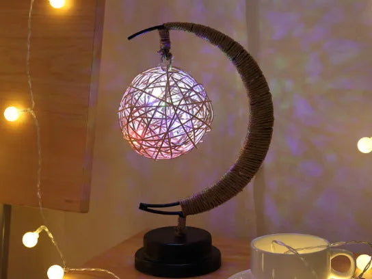 LED modelling lights with star, moon, apple, and round ball shaped covers on a warm white Christmas decoration display