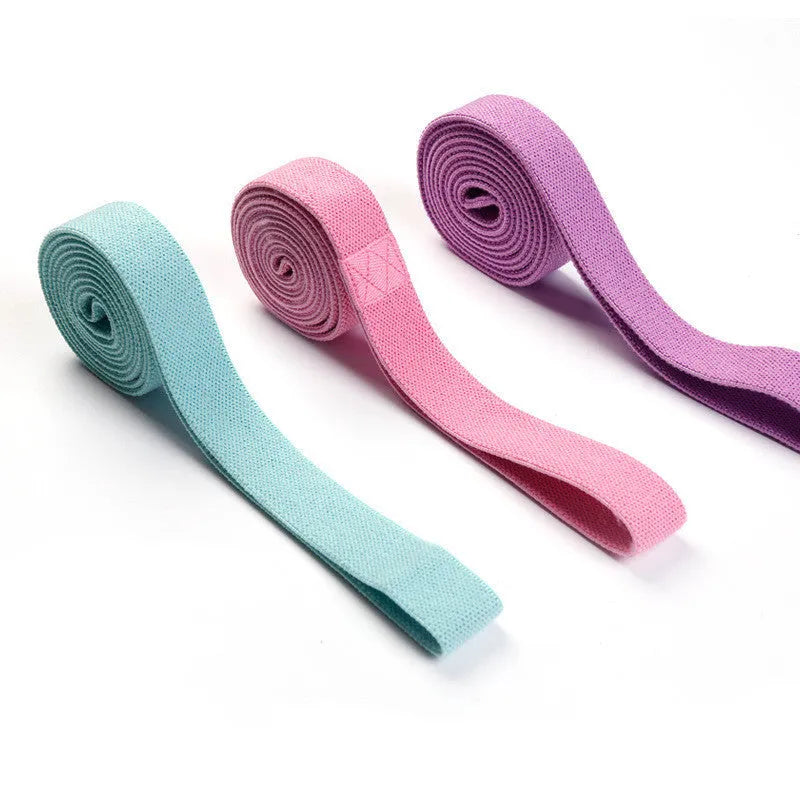 2-metre long elastic yoga stretch band in pink, purple, and black with storage mesh bag