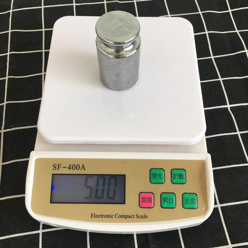 SF-400A digital kitchen scale with display, showing weight measurement on a clean surface.