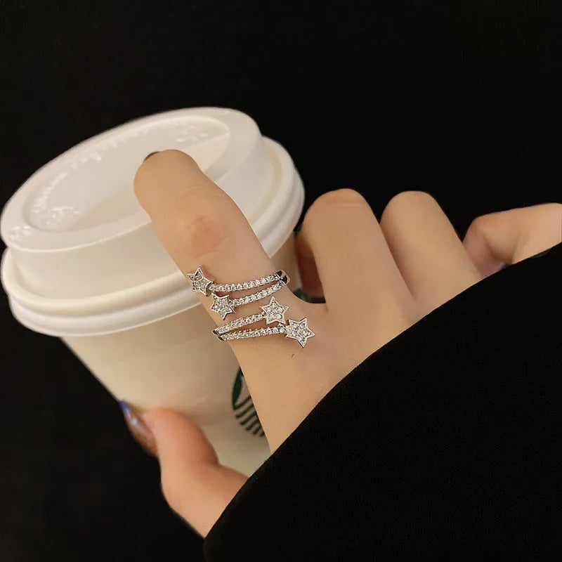 Multi-layer micro-inlaid five-pointed star zircon ring in silver, adjustable copper band with gold-plated gems