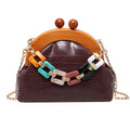 Women's shell-shaped PU clutch bag with diamond element and chain strap in black
