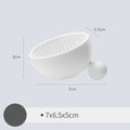Small silicone makeup brush cleaning scrub tray in white with raised textured centre for removing foundation residue